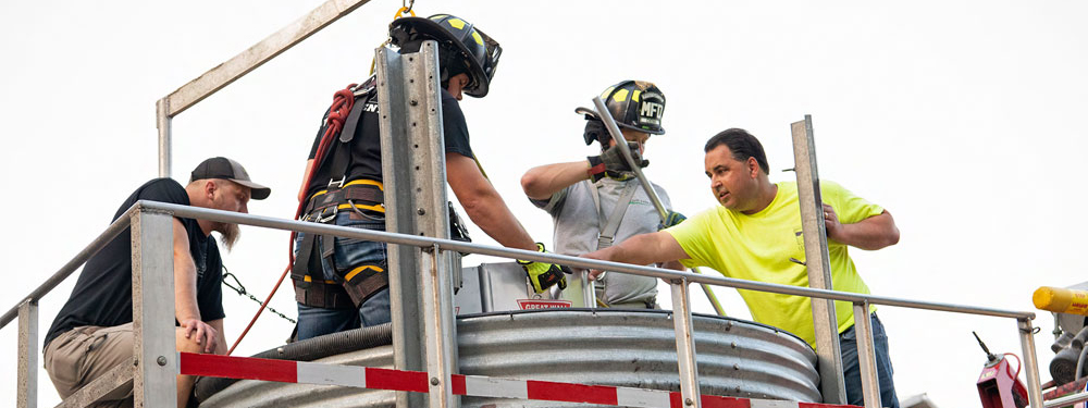 Firefighters performing a grain bin safety practice exercise