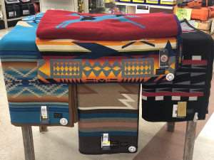 Blankets piled on a table in a retail store