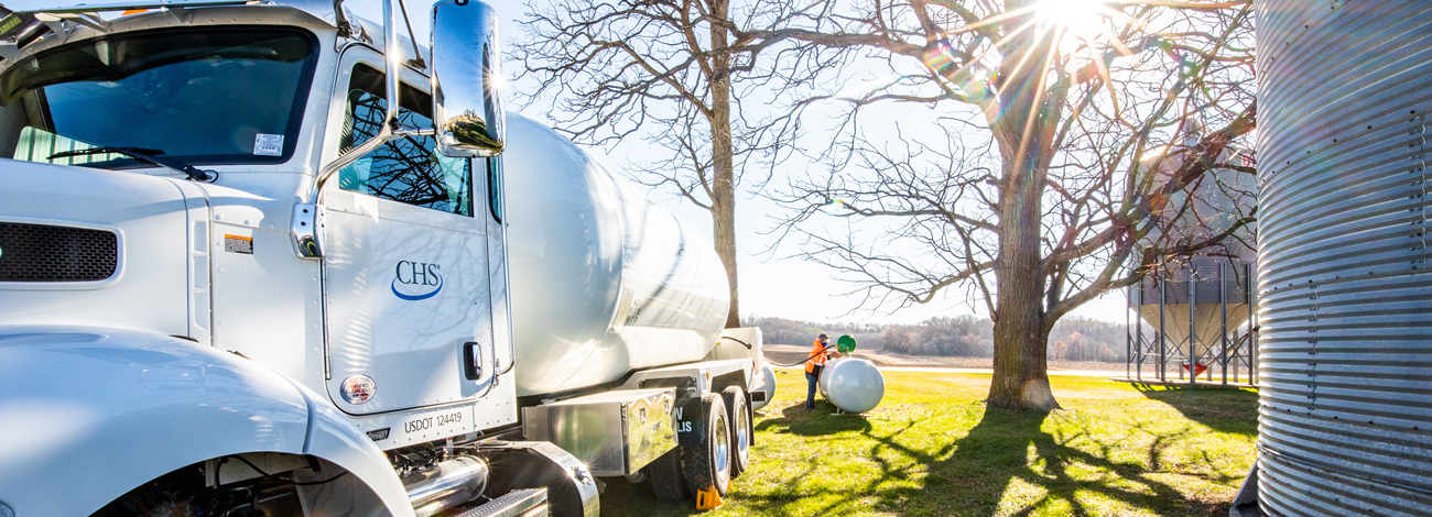 Man refilling propane tank from truck