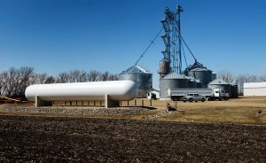 Propane tank with grain bins in the background