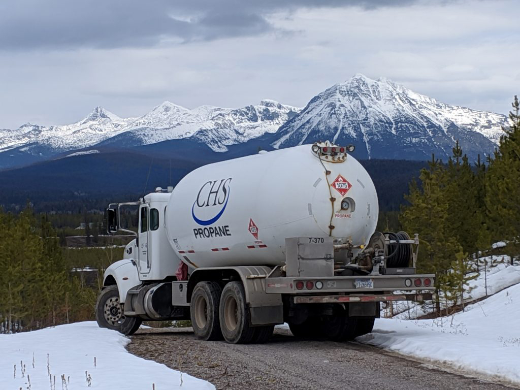 CHS propane truck driving down a mountain road