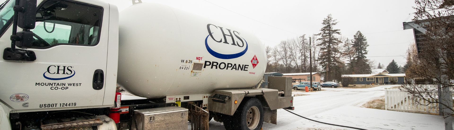 A propane truck parked at a house.
