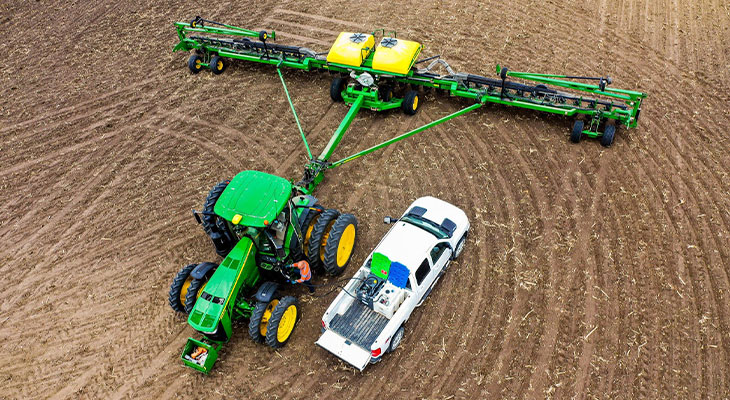 Tractor and truck in a field planting
